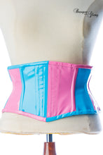 Load image into Gallery viewer, Pink and blue PVC bubblegum corset on a mannequin with 'Basque Glory' branding.